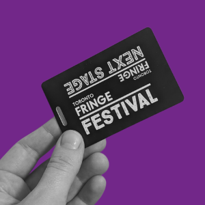 A hand olds a Festo card, a black card with "Fringe Festival" and "Next Stage" on it in white lettering