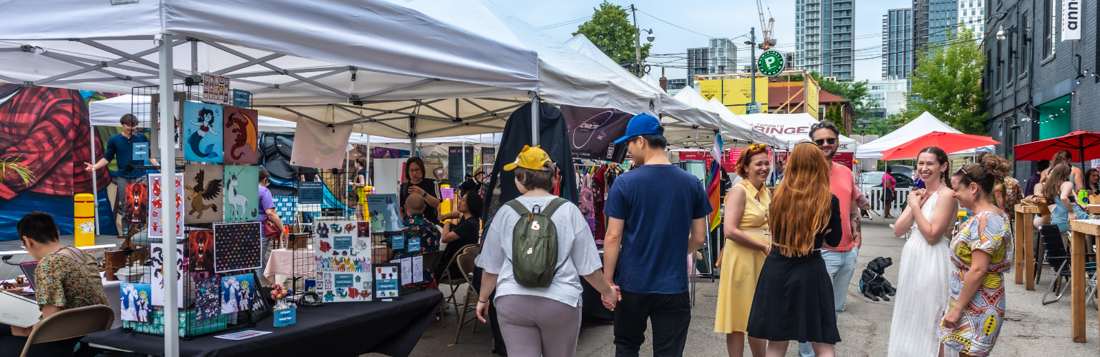 Patrons browse the stalls at the artisan market on the Fringe patio