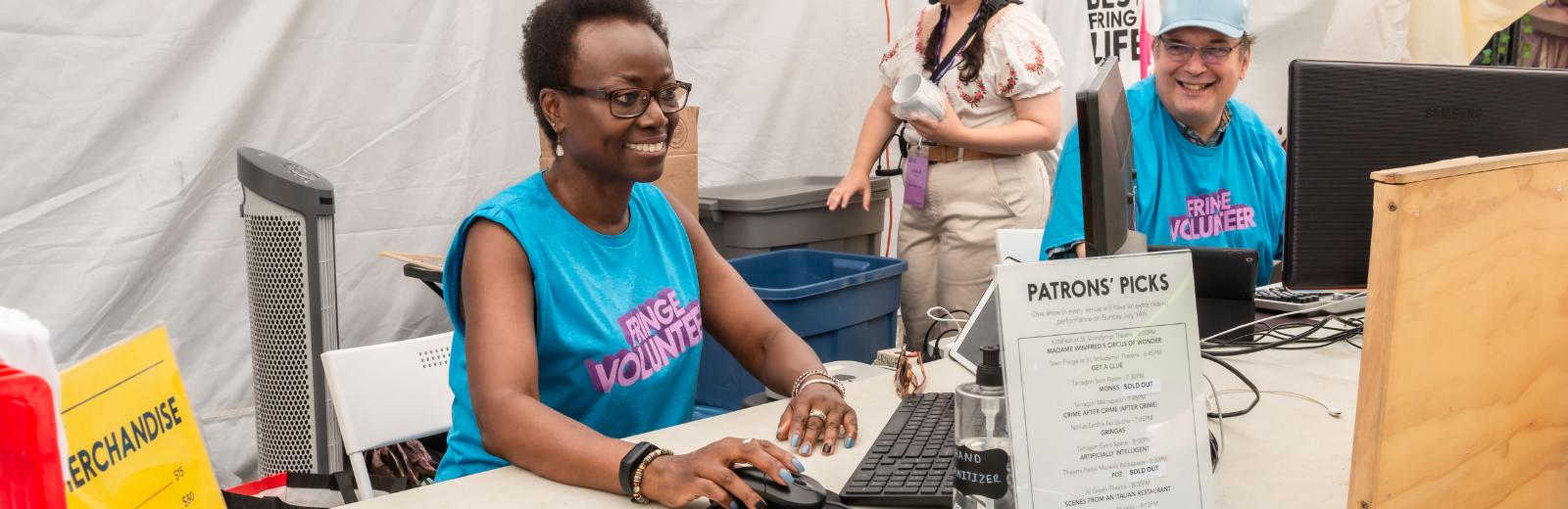 Fringe volunteers serve patrons at the box office