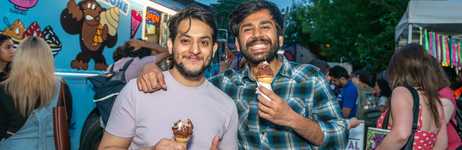 Fringe patrons eat ice cream cones at the Fringe patio
