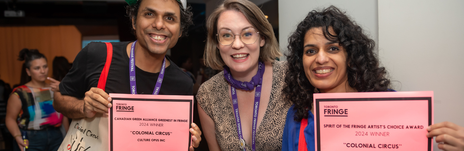 Fringe artists show off their awards smiling at the camera